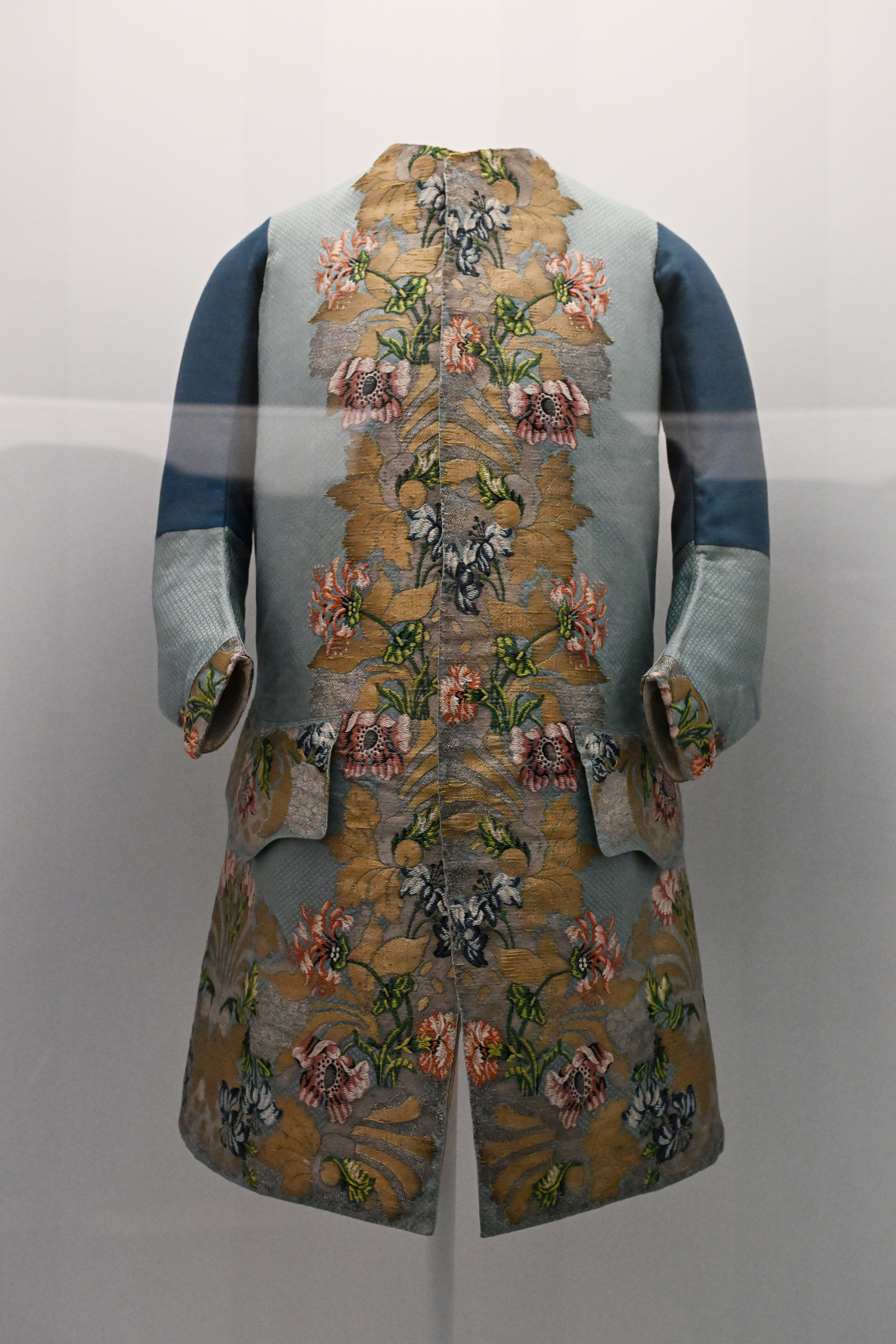 Embroidered floral pattern on a display coat with blue sleeves