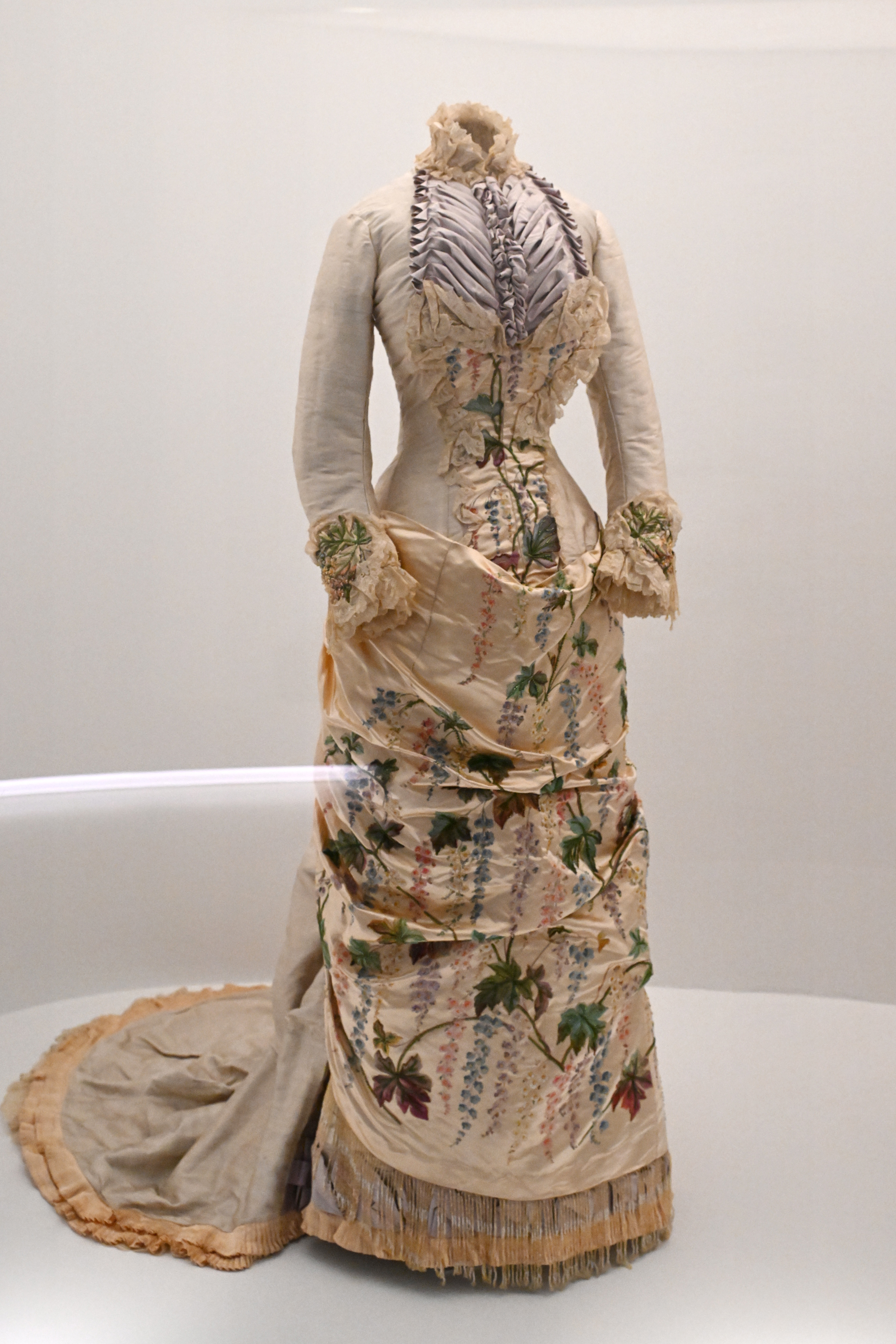 Vintage dress with floral patterns and fringed skirt on display