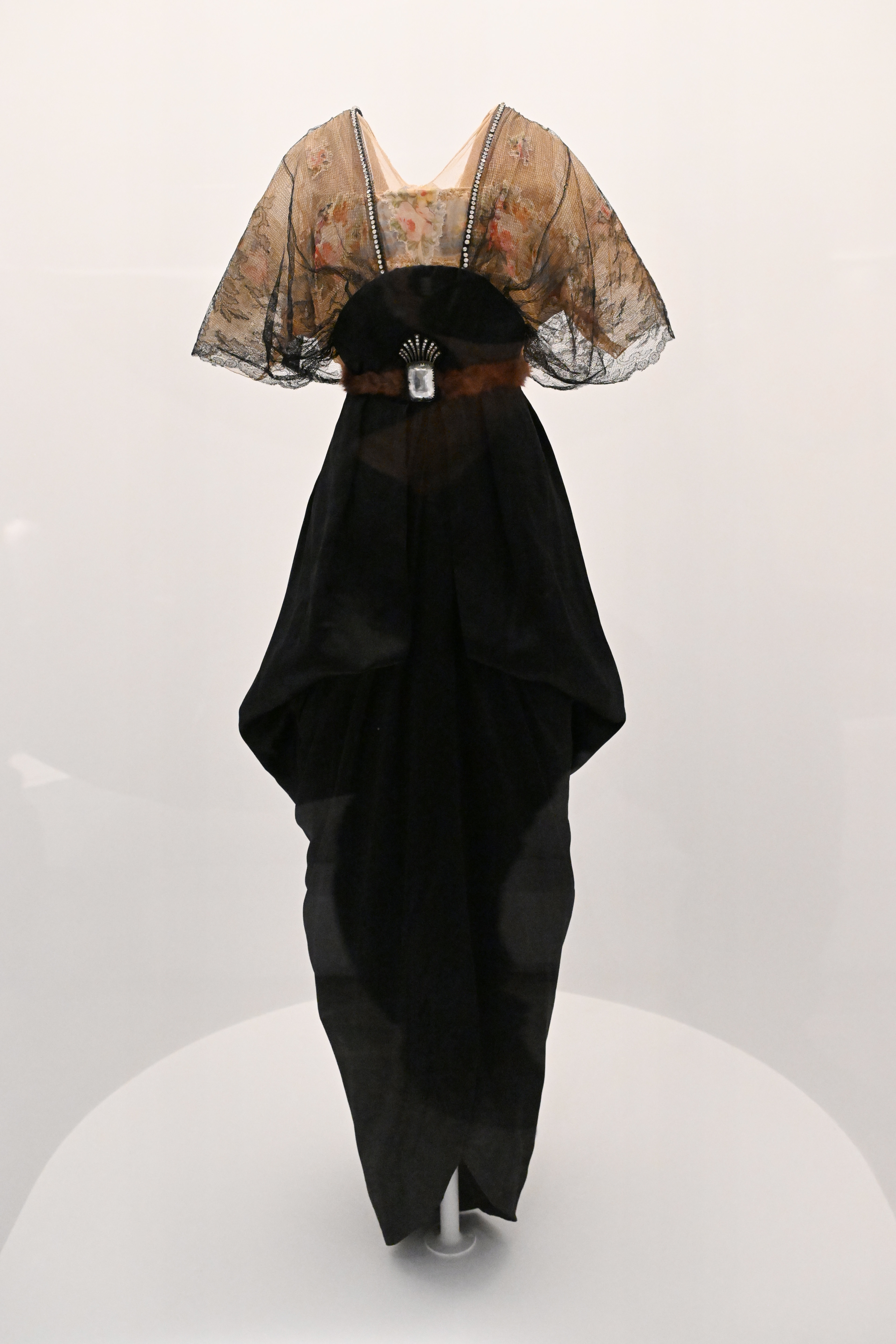 Black gown with lace detail on display, no people present