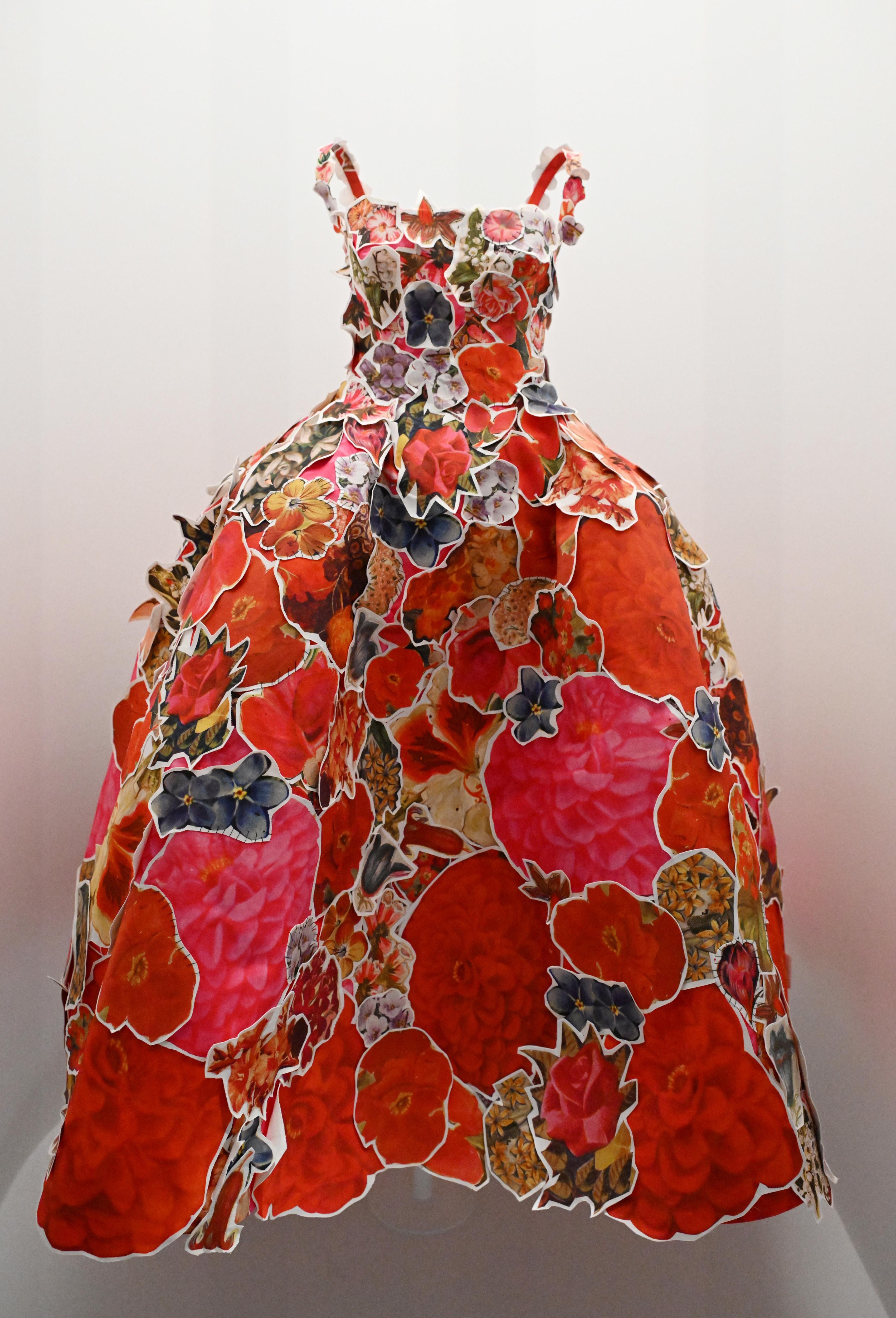 Floral print ball gown with full skirt and spaghetti straps on a mannequin