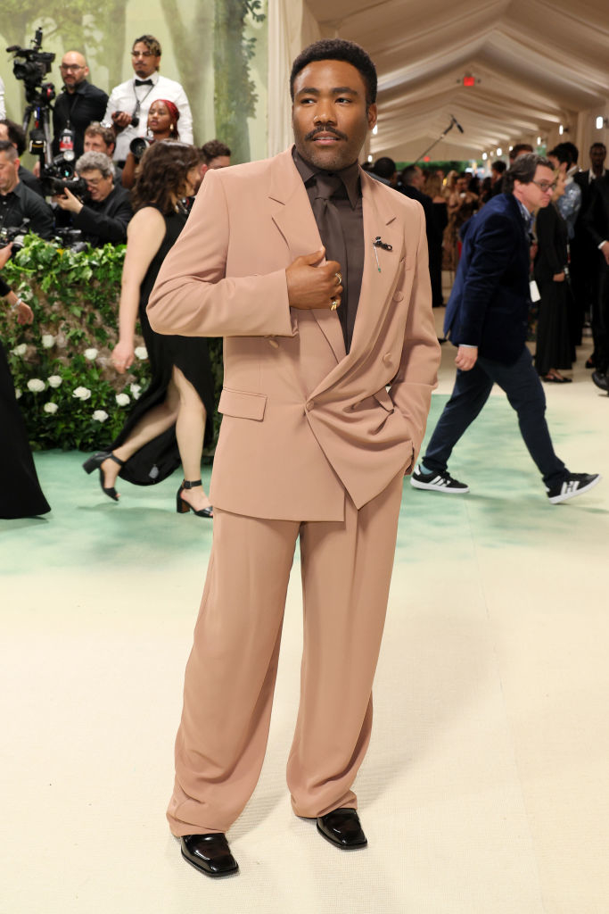 Donald Glover in unique suit with oversized bow at a celebrity event