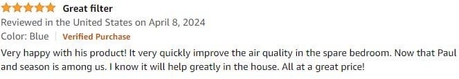 Five-star review with text praising a product for quick improvement in spare bedroom organization, mentioning season change