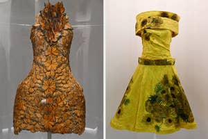 Two historical dresses on display, one with floral patterns and one with a leaf design, no persons present