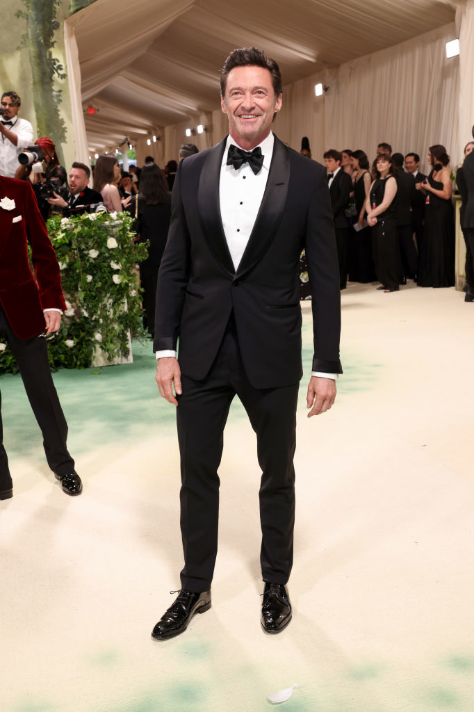 Hugh Jackman in a classic black tuxedo with a bow tie on the red carpet