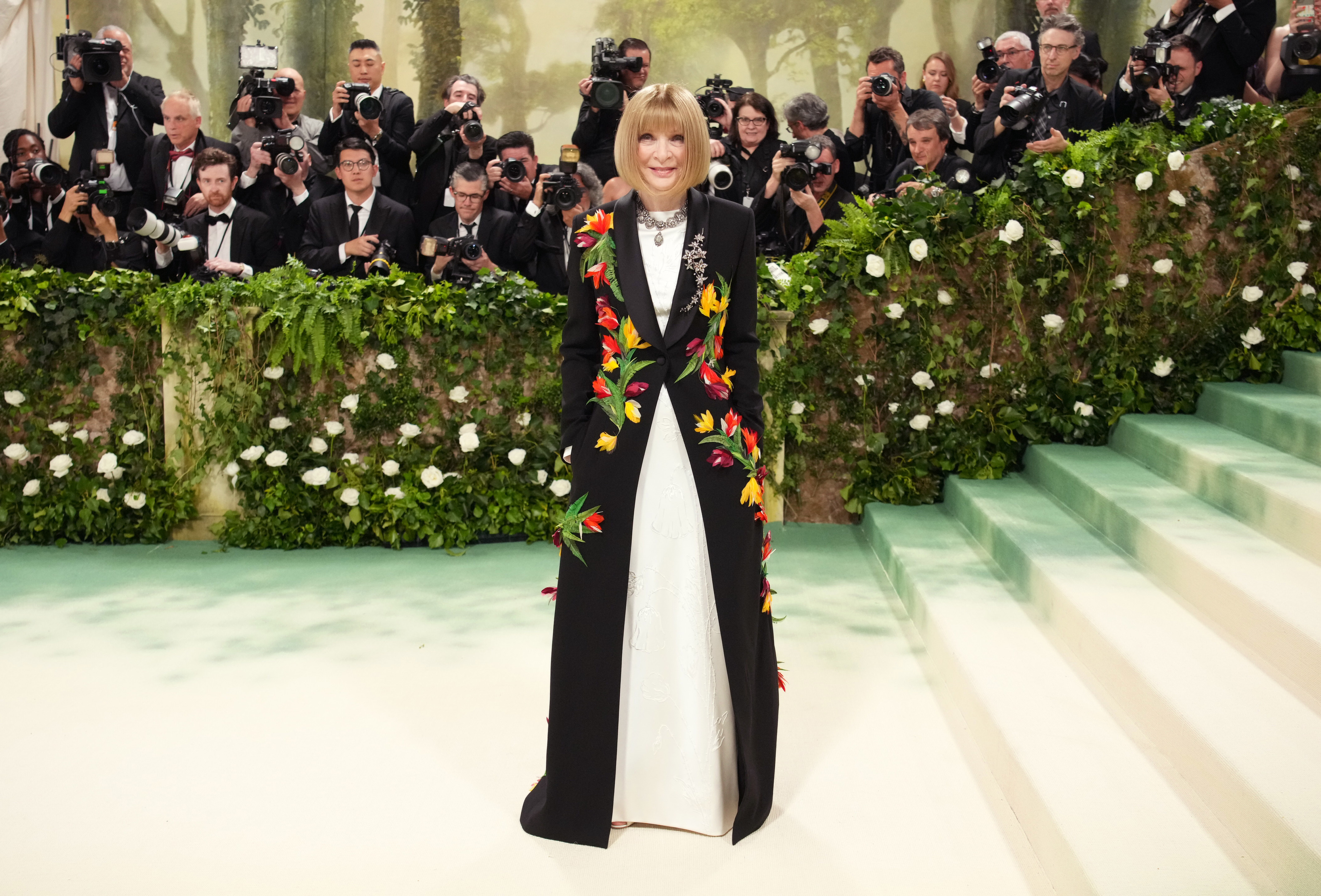 Anna Wintour at an event wearing a floral-patterned long coat