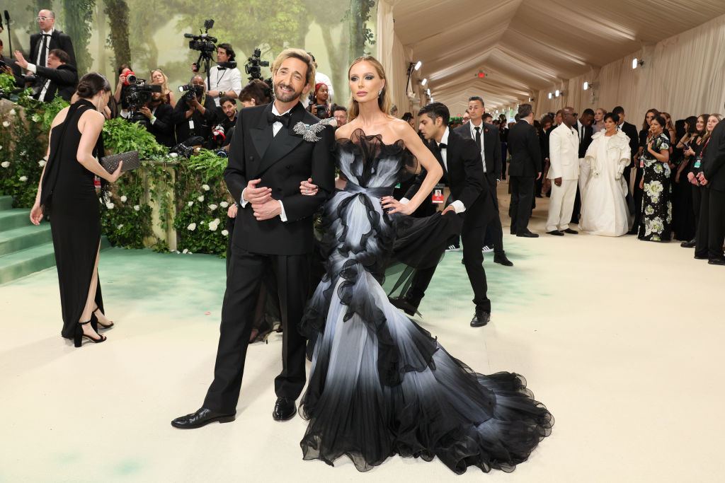 Adrien in a tuxedo and Georgina in a voluminous tiered gown