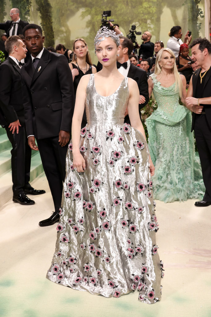Amanda Seyfried in a floral embellished gown with a headpiece at an event