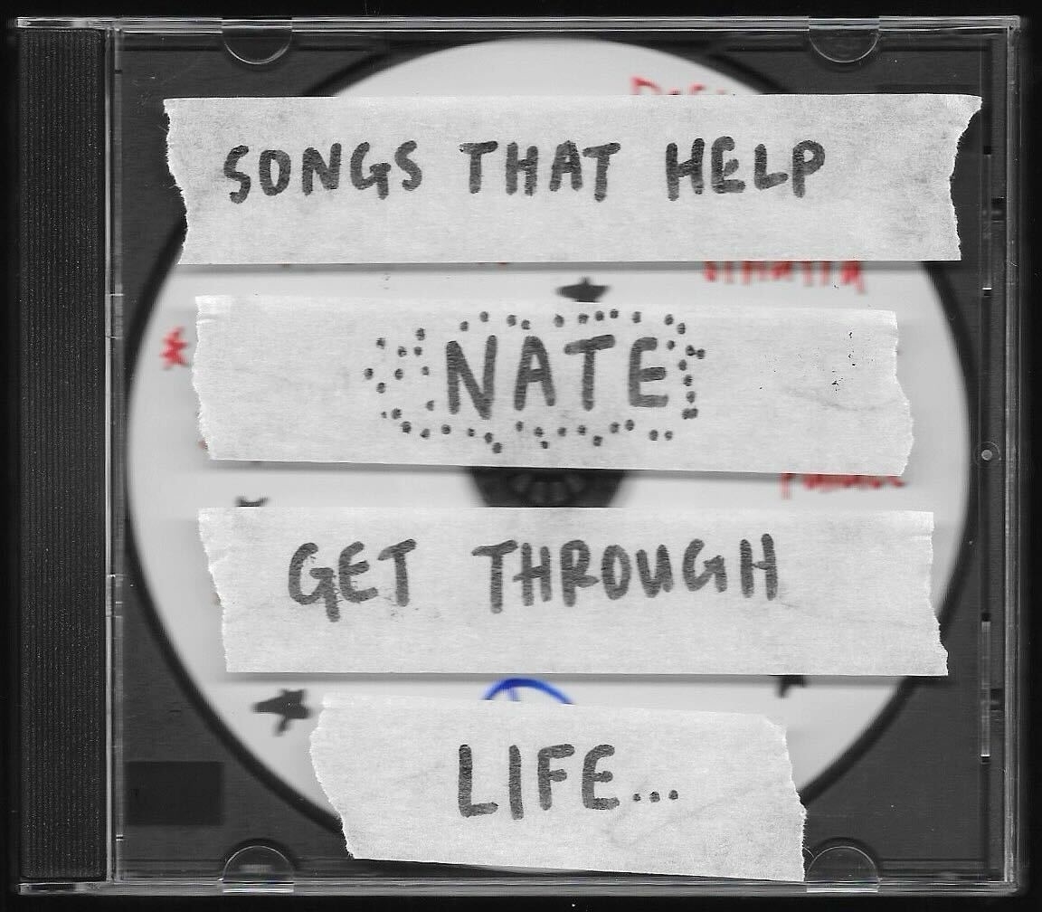 A CD case with handwritten labels reading &quot;SONGS THAT HELP&quot;, &quot;NATE&quot;, and &quot;GET THROUGH LIFE...&quot;