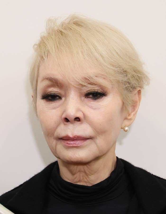 写真には、黒いタートルネックのセーターを着た女性がいます。