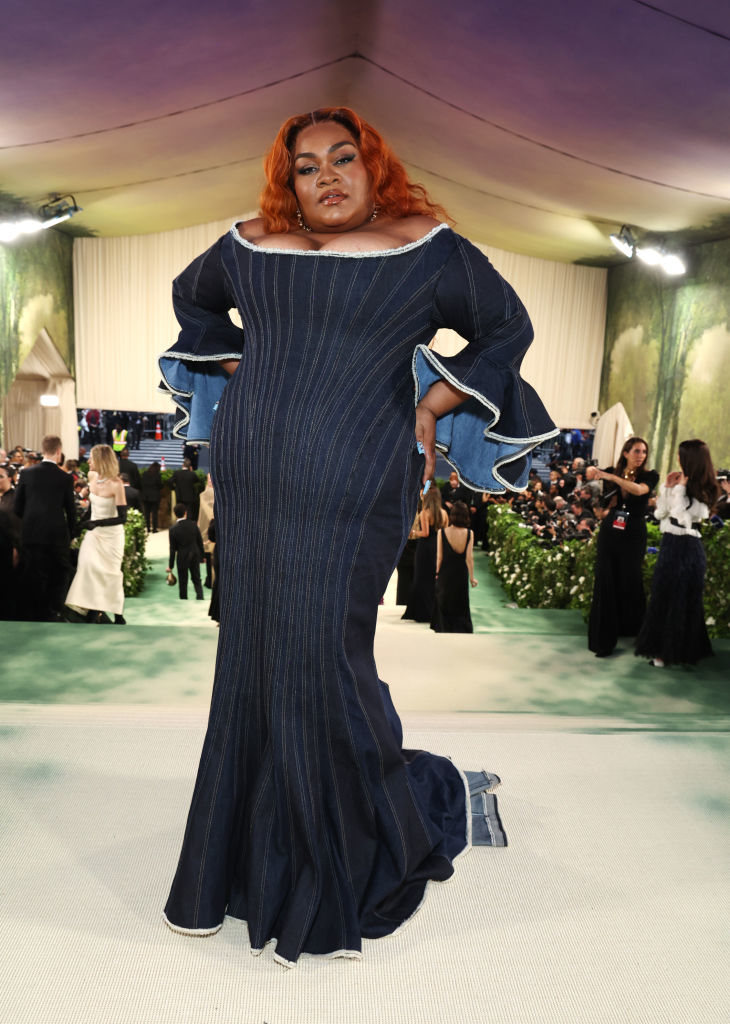 Da&#x27;Vine Joy Randolph in a striped, ruffled gown with hand on hip at an event