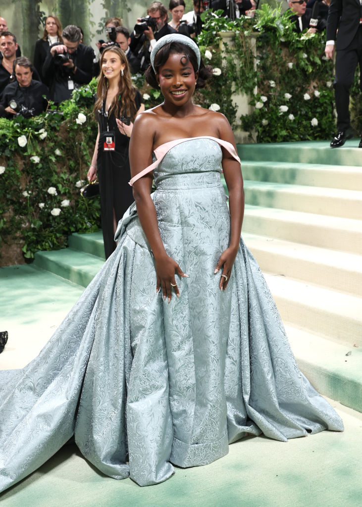 Amanda Gorman in off-shoulder gown with floral pattern at event