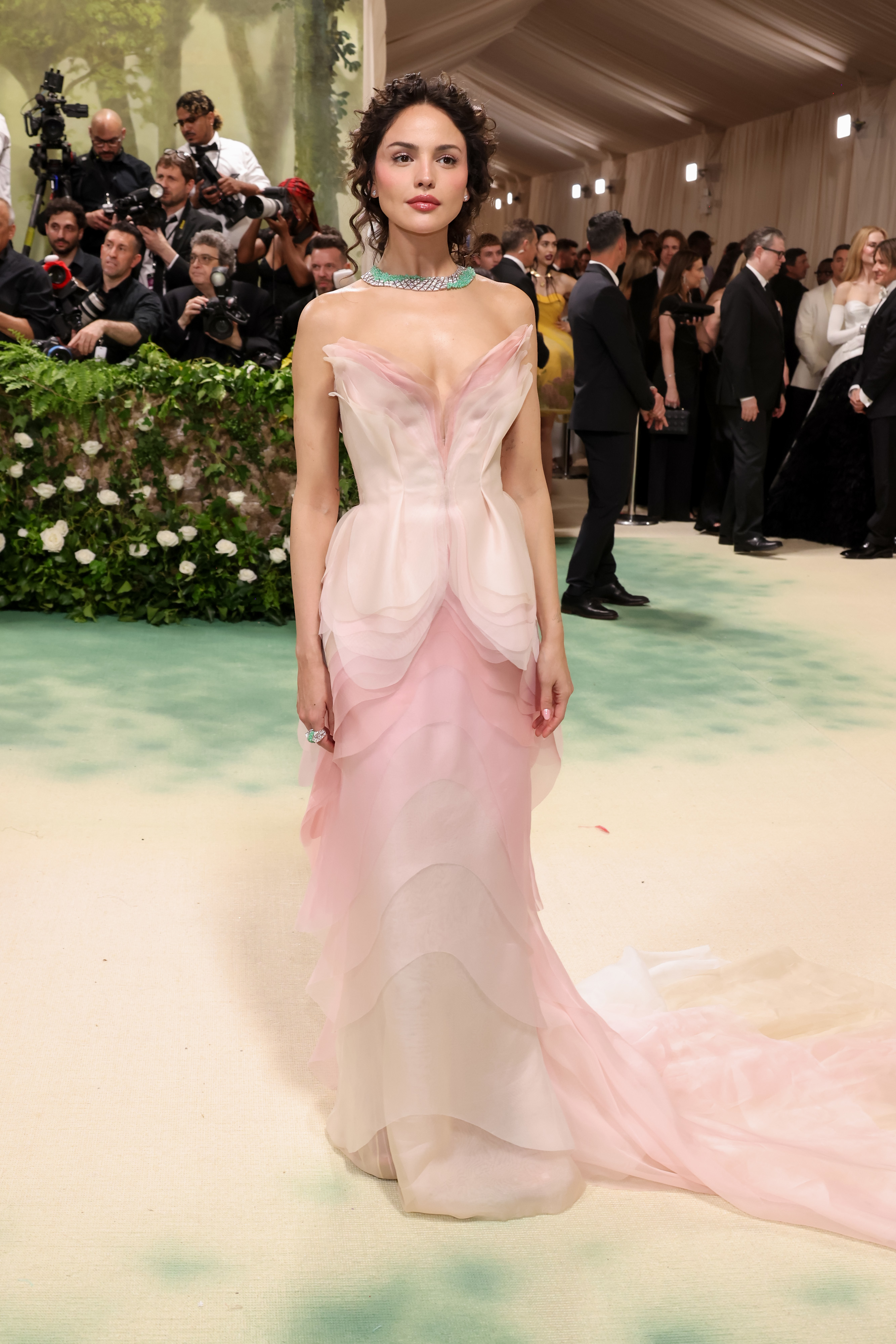 Mujer en un vestido de gala con capas y joyería elegante en un evento