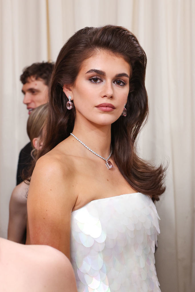 Kaia Gerber in a white sequined dress with diamond necklace and earrings