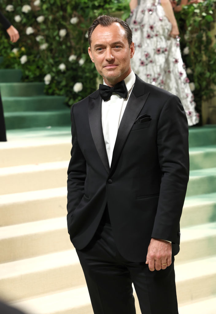 Jude Law poses in a classic tuxedo at an event