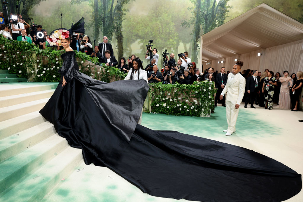 Zendaya in elaborate gown with long train and bouquet headpiece