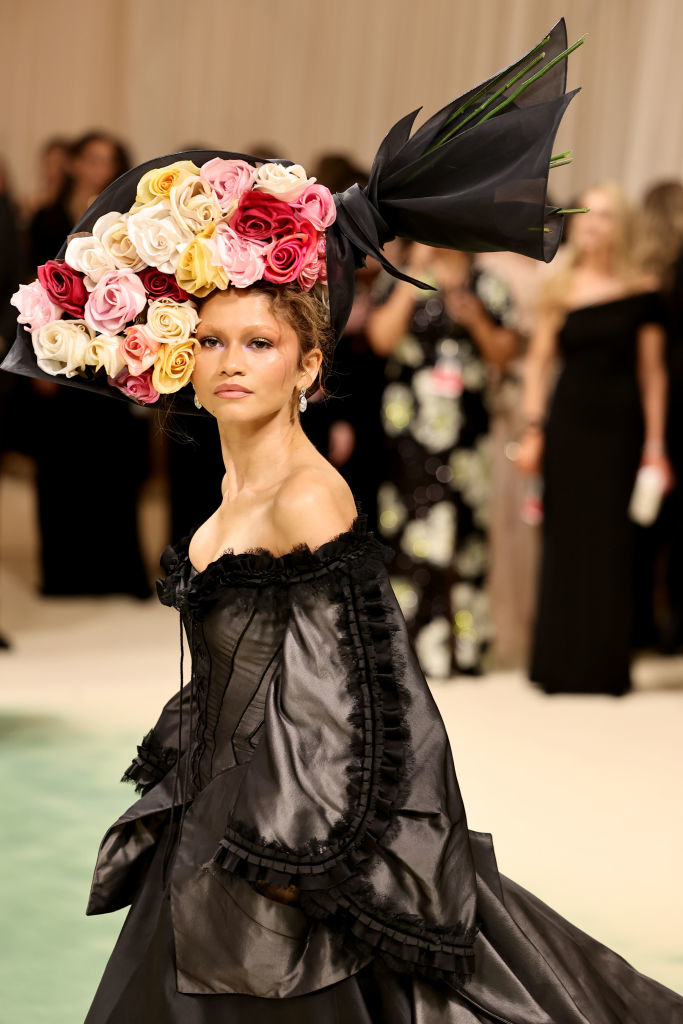Zendaya with an extravagant floral headpiece and ruffled black at a formal event