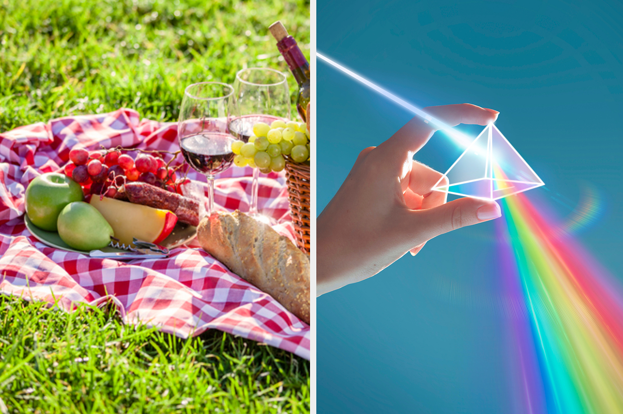 Picnic setup on a checkered blanket with various foods and a hand refracting light through a prism creating a rainbow