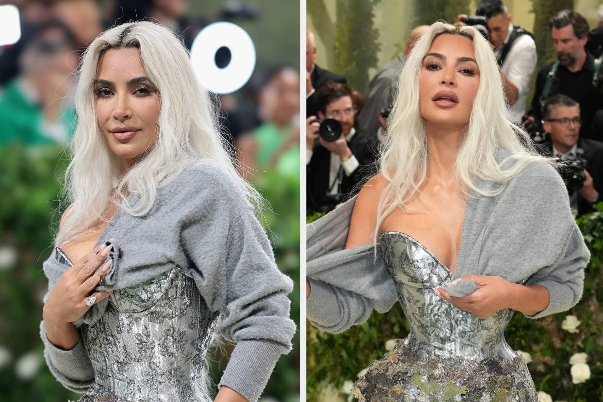 Kim Kardashian in a silver dress with a grey cardigan at an event, posing for cameras