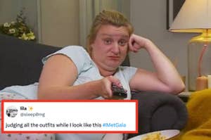 Person lounging on couch with remote, reacting to Met Gala outfits, as per tweet