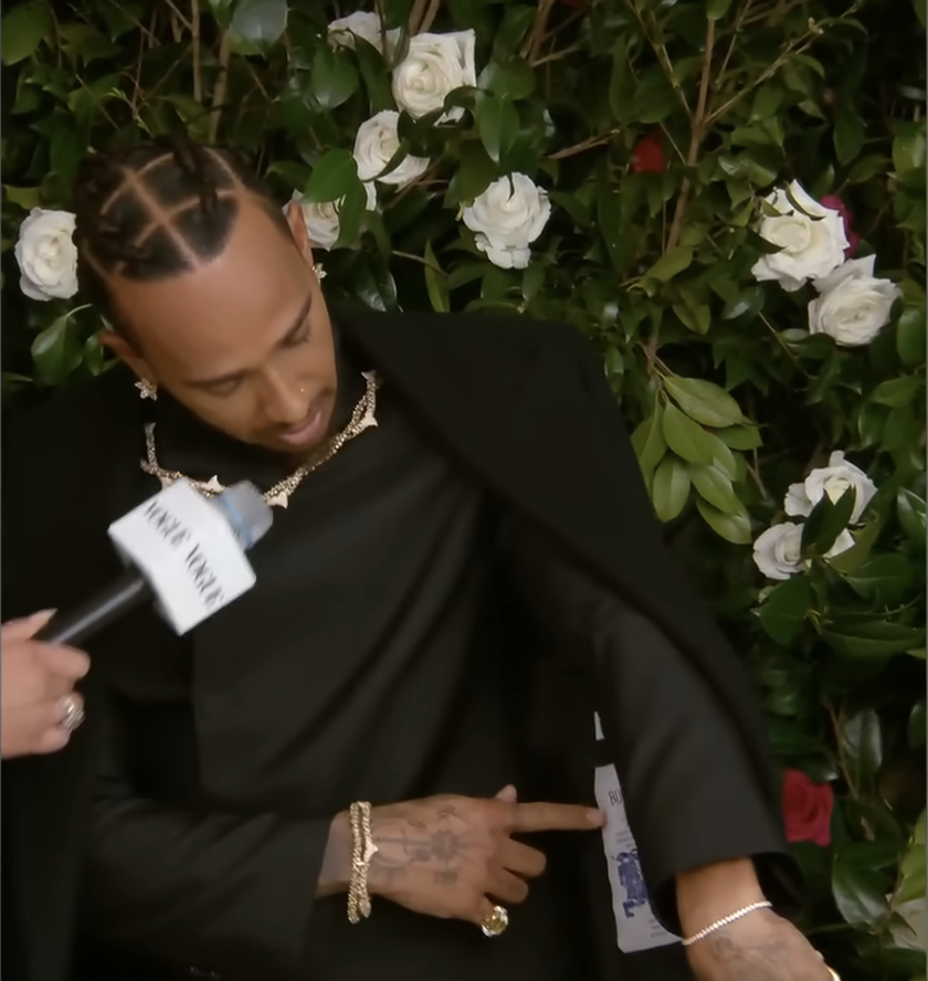 Lewis Hamilton showing the details of his ensemble at the Met Gala