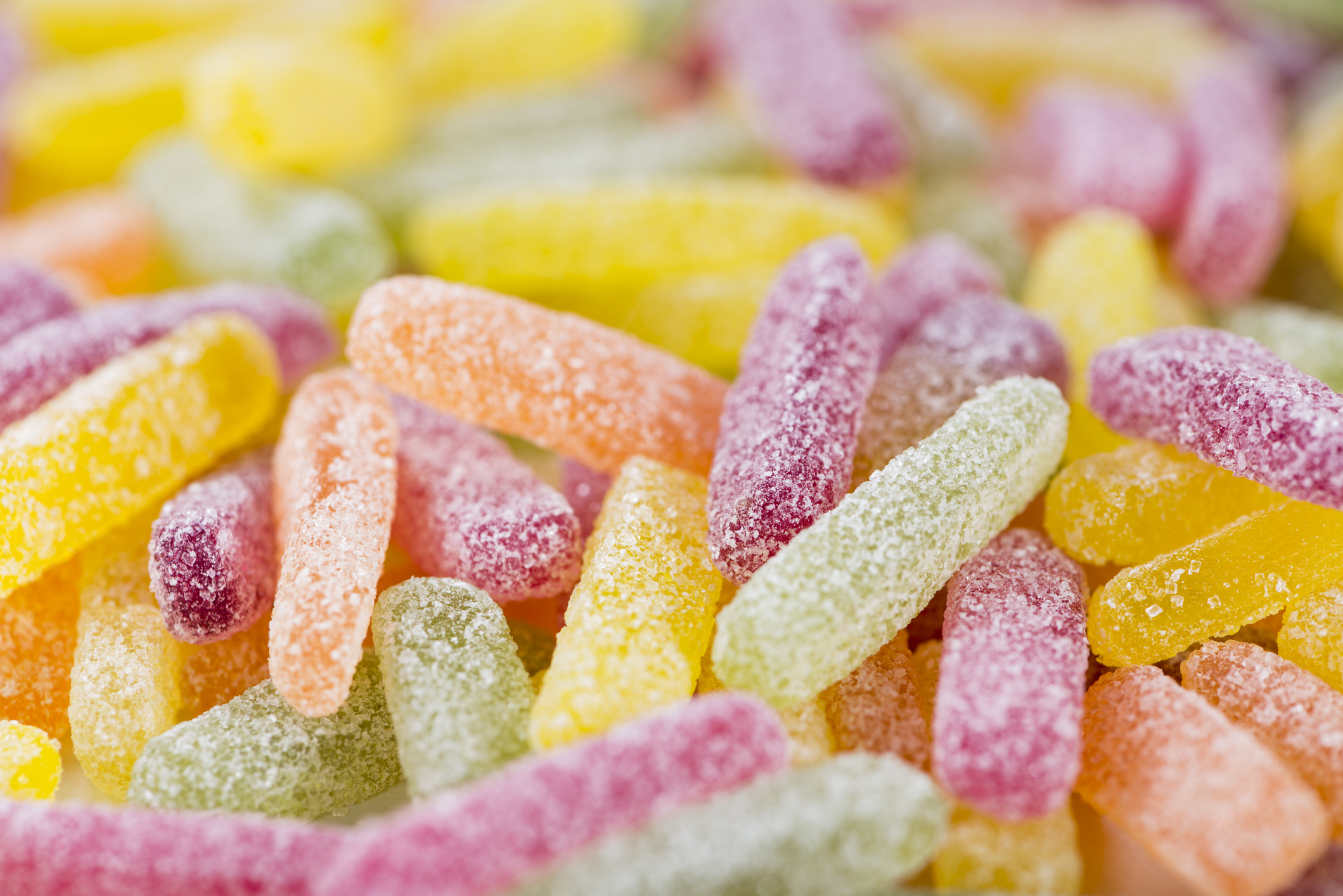 Assorted sugary gummy candies in a pile, close-up