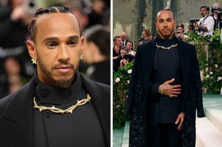 Lewis Hamilton in a black outfit with a gold chain collar, giving an interview at an event