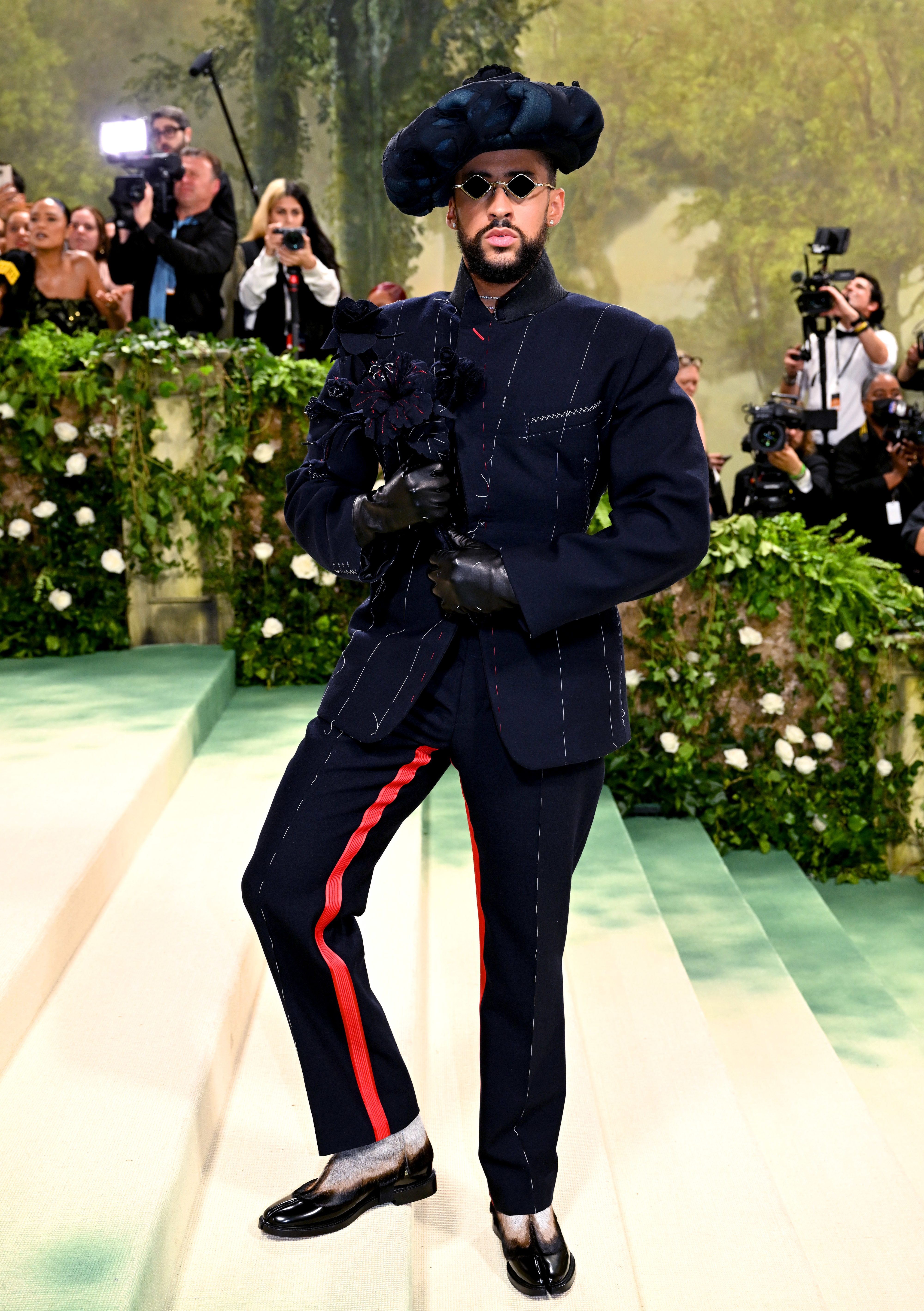 Bad Bunny standing on the steps of the Met at the 2024 Met Gala