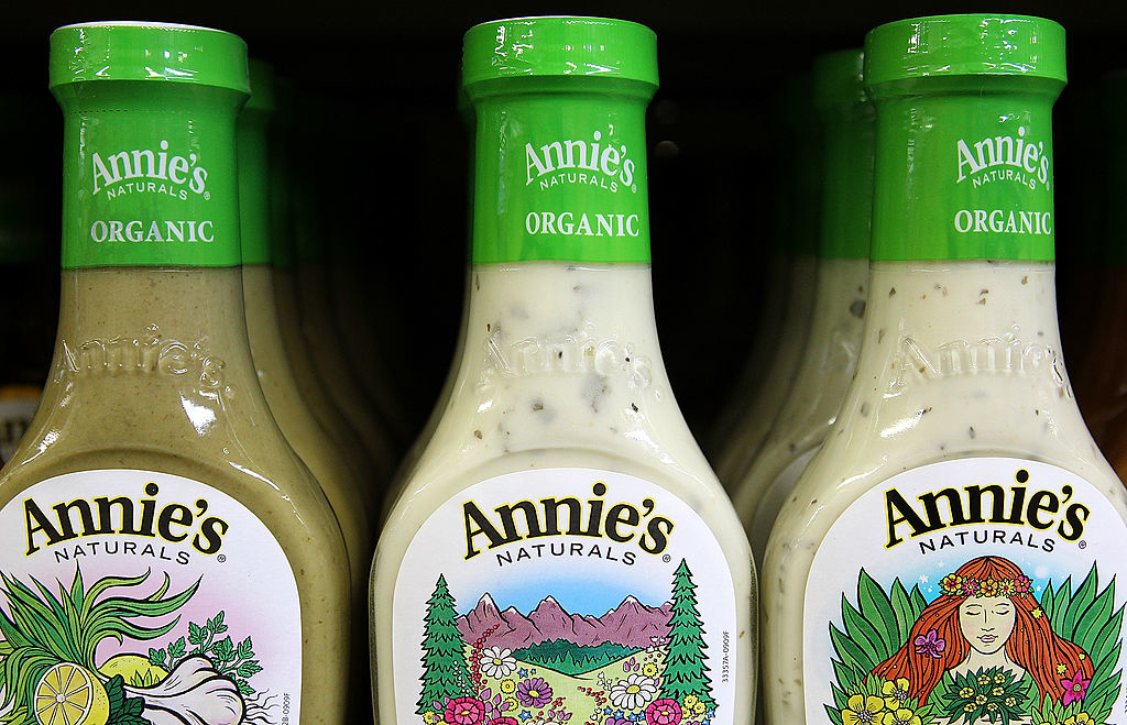 Three bottles of Annie&#x27;s Organic salad dressing on a shelf