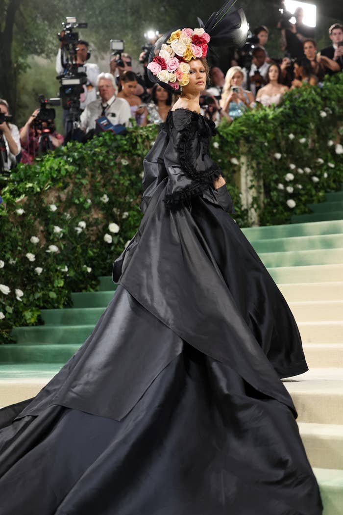 Zendaya in a long-flowing gown and a floral headpiece