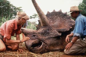 Characters Ellie Sattler and Alan Grant from Jurassic Park tending to a sick Triceratops