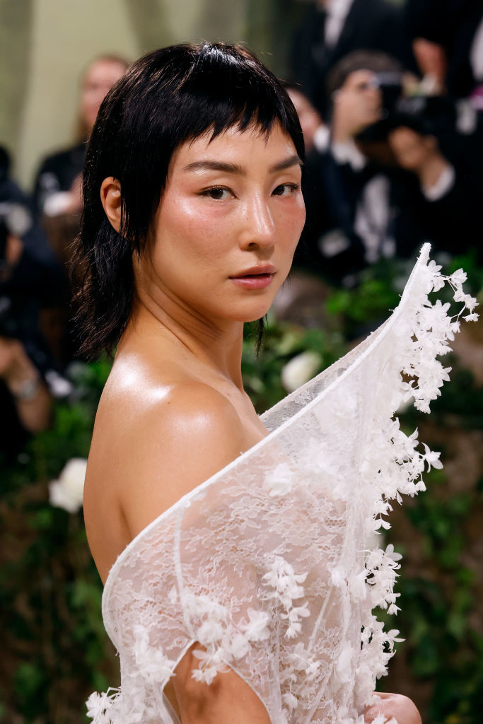 Greta in a lace dress with floral details at an event