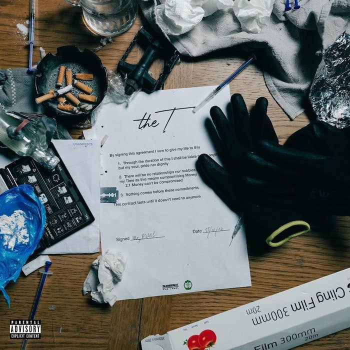 Album cover with scattered objects and a faux contract signed by &quot;the 1,&quot; implying a break from constraints