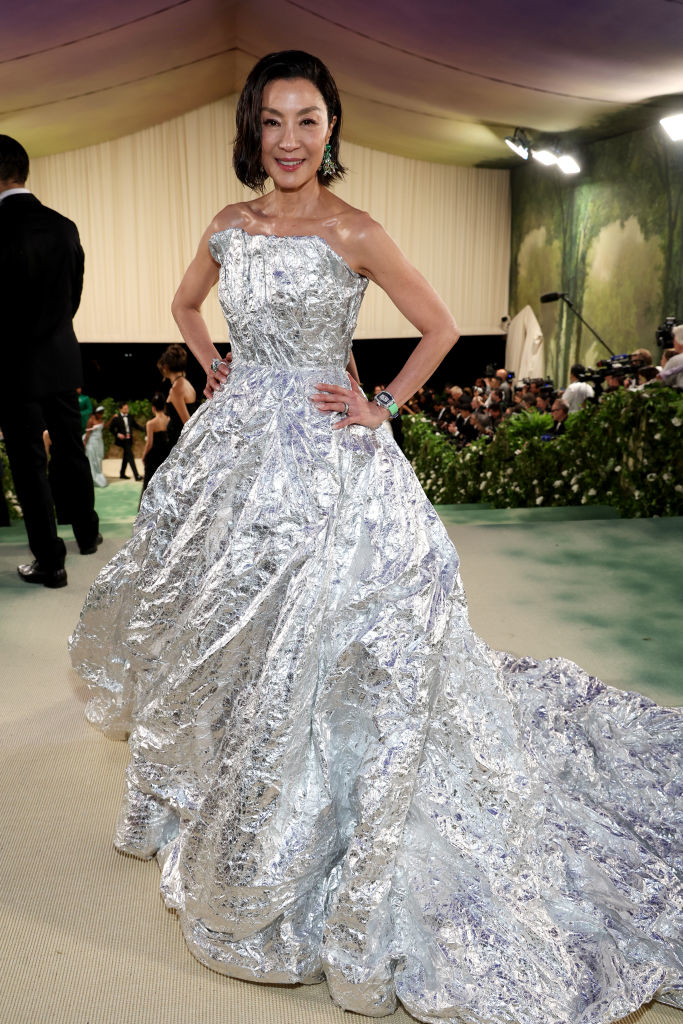 Michelle in elaborate metallic gown with fitted bodice and full skirt at an event