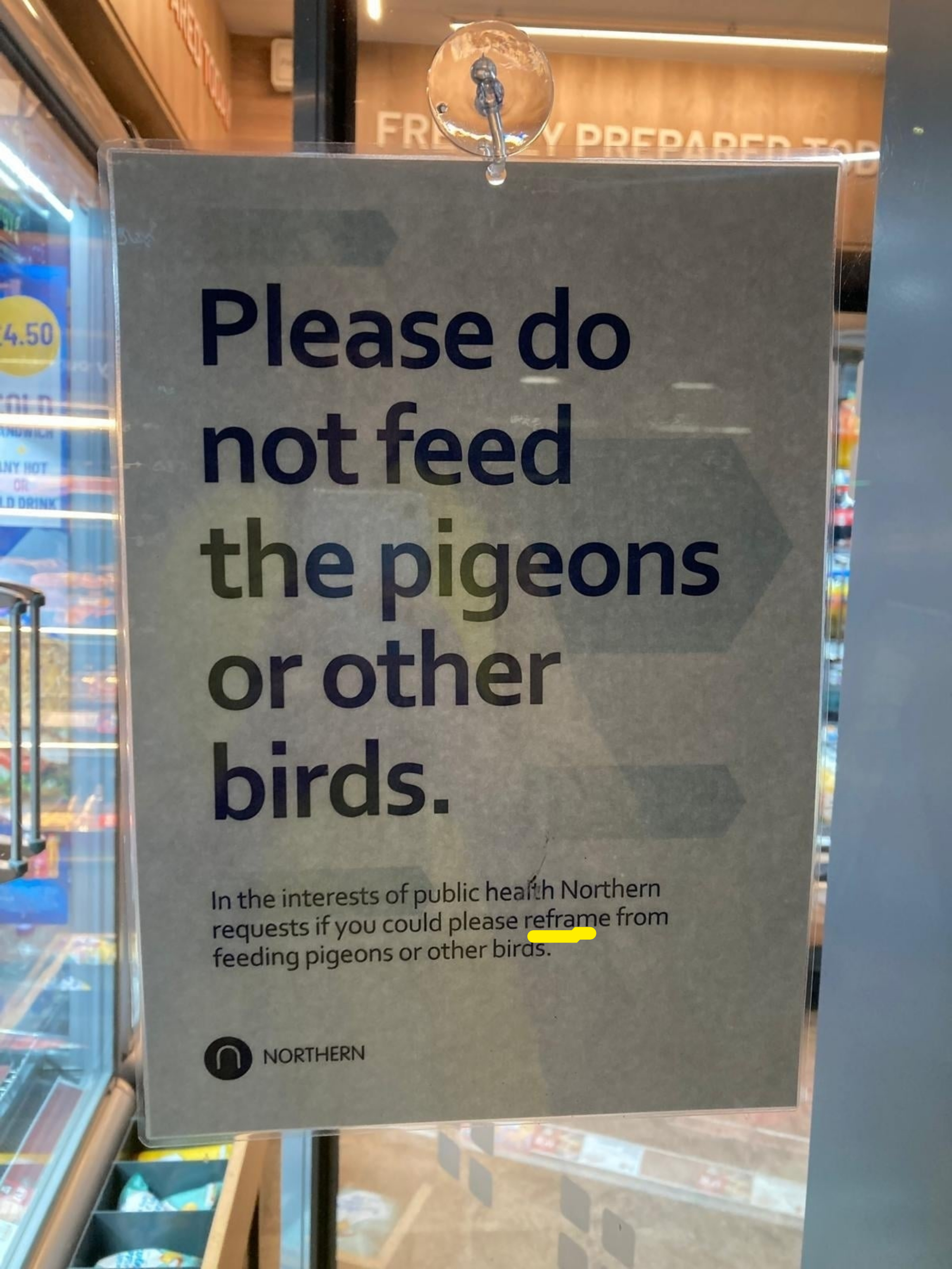 Sign requests not to feed pigeons or birds to prevent encouraging them inside the store