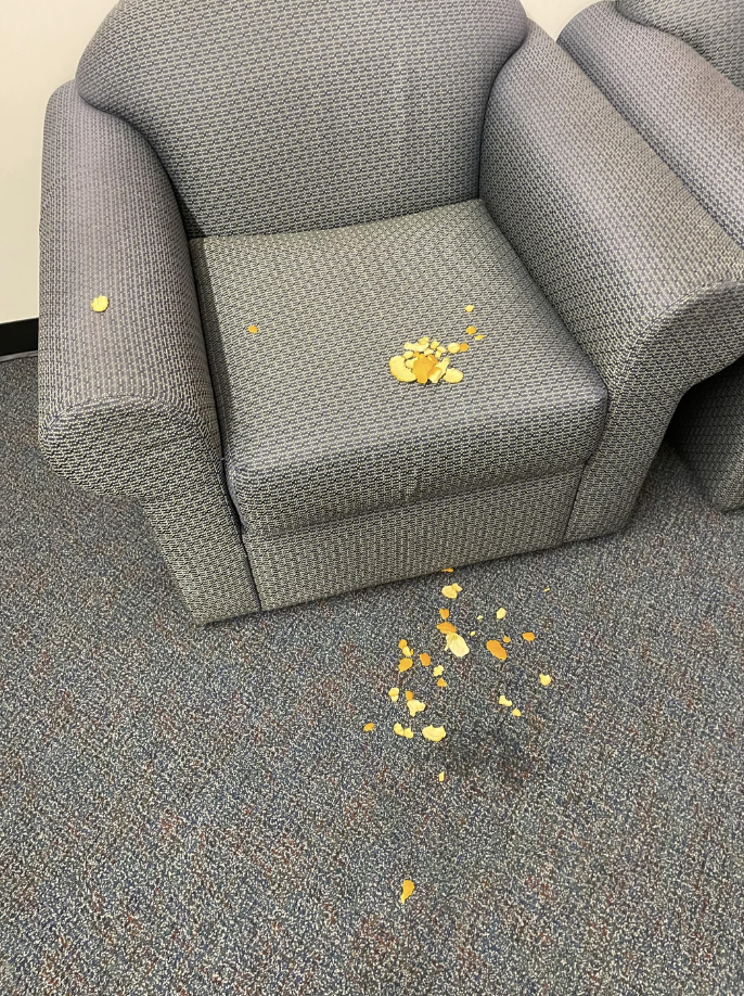Spilled snack on an office chair and carpet