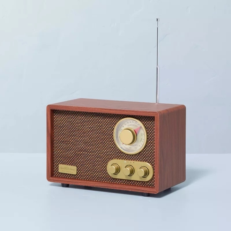 Vintage-style radio with wood casing and retro dials on a plain surface