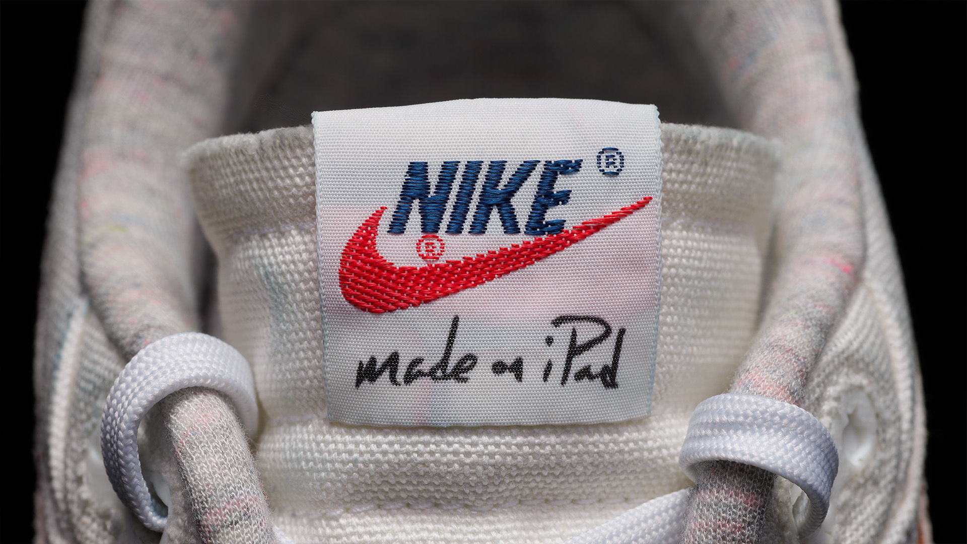 Close-up of a Nike sneaker tongue with the logo and &quot;made on iPad&quot; text