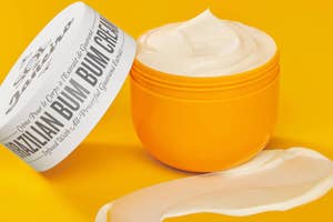 Open container of Brazilian Bum Bum Cream with a smear of the product in front