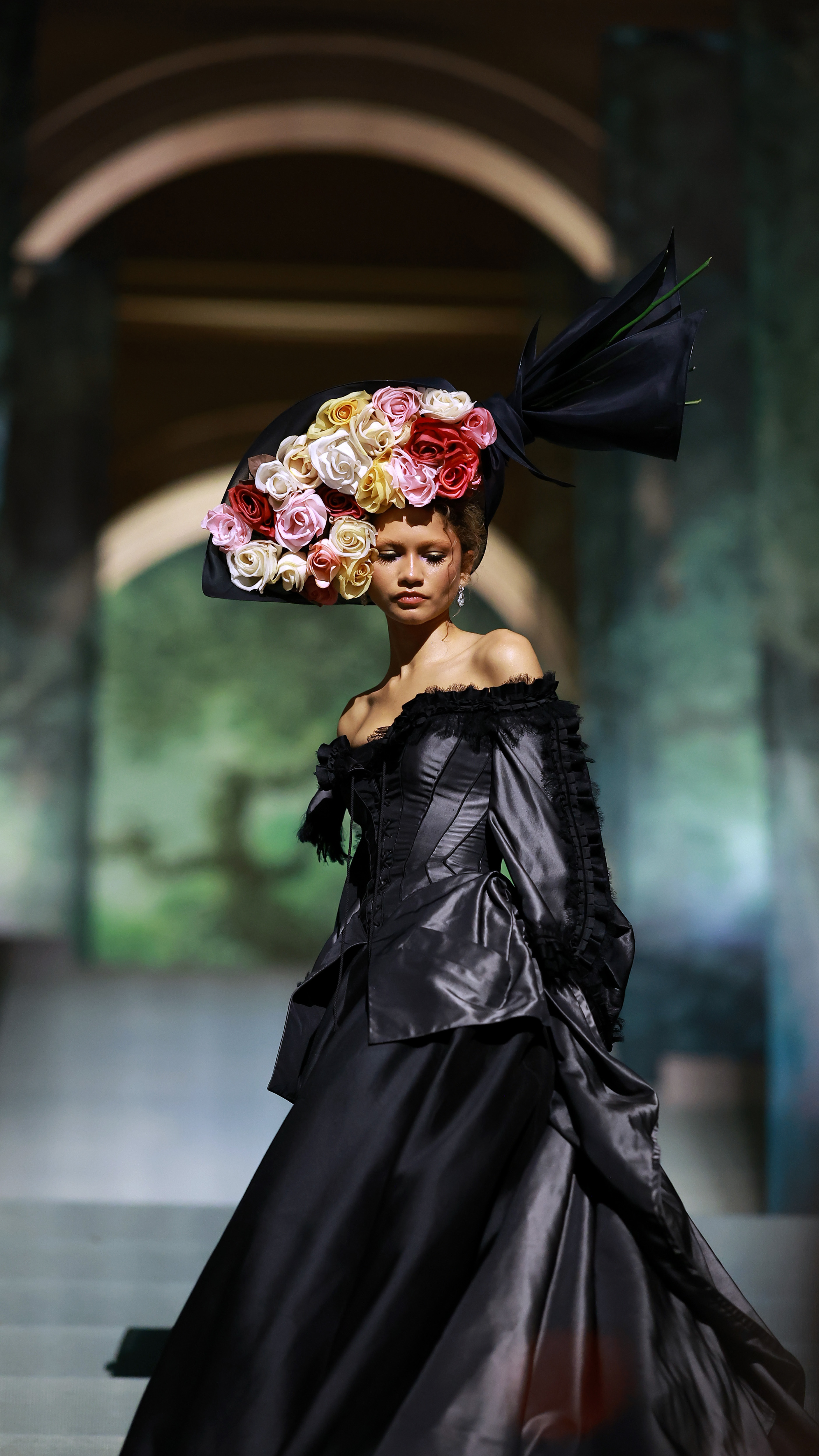 Zendaya in an elaborate black gown with an oversized floral headpiece at the 2024 Met Gala
