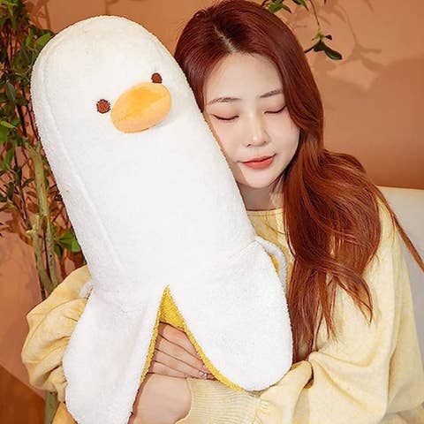 person holding a big plush banana duck toy