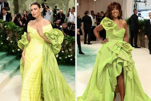 Two individuals at an event, both wearing elaborate green dresses with ruffle details; one has a structured silhouette with sleeves