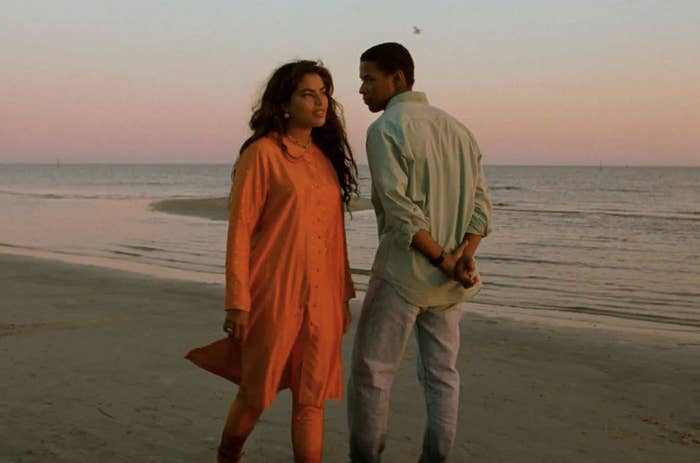 Demetrius and Mina (Denzel Washington and Sarita Choudhury), walking on a beach at sunset gazing romantically at each other.