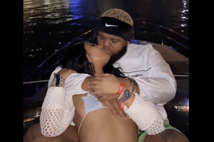 Two individuals embracing affectionately on a boat at night