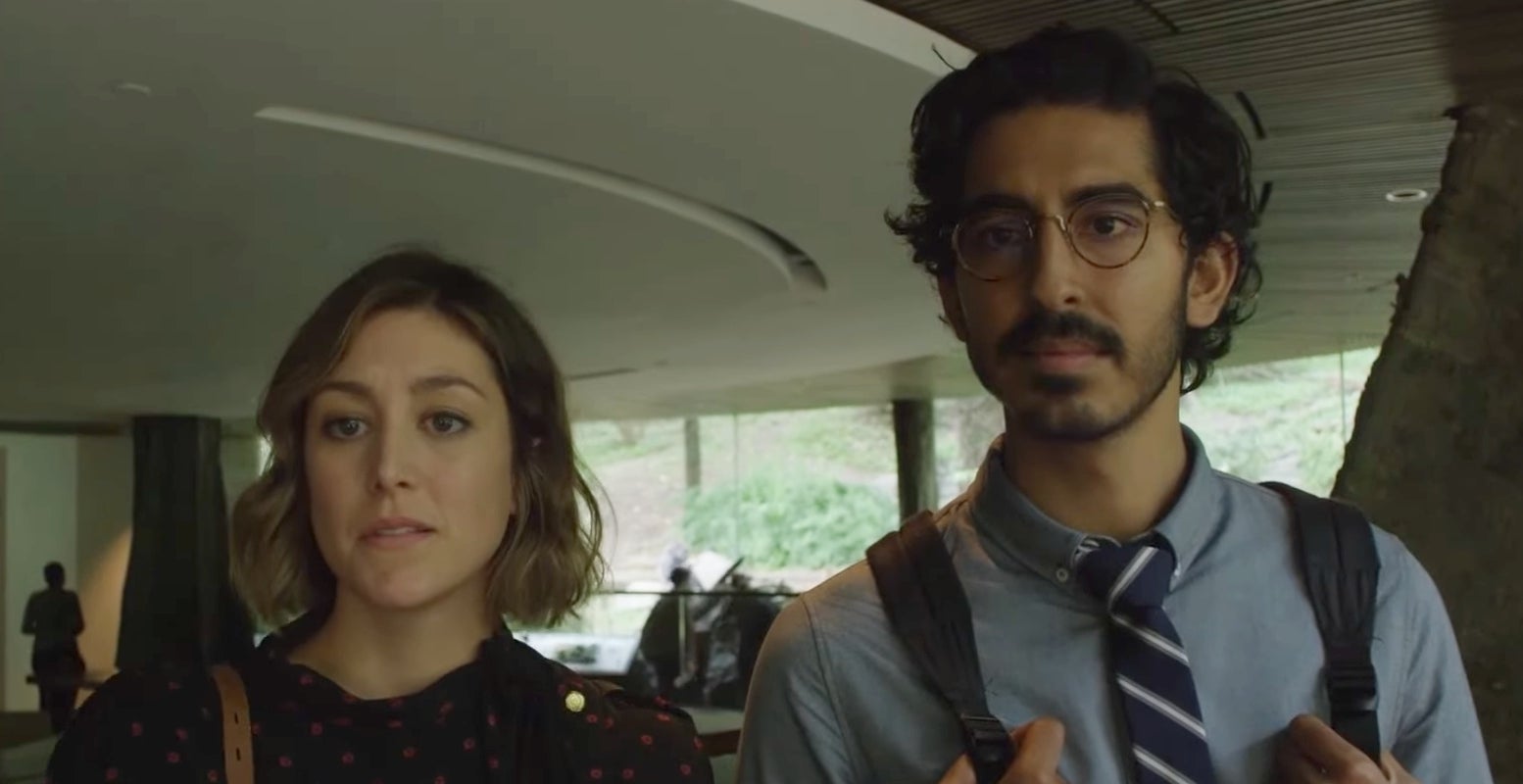 Two actors portraying characters in a scene from a Prime Video show, standing together in an indoor setting