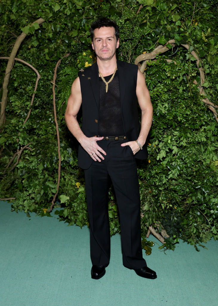 Andrew Scott in a black sleeveless top and trousers at an event