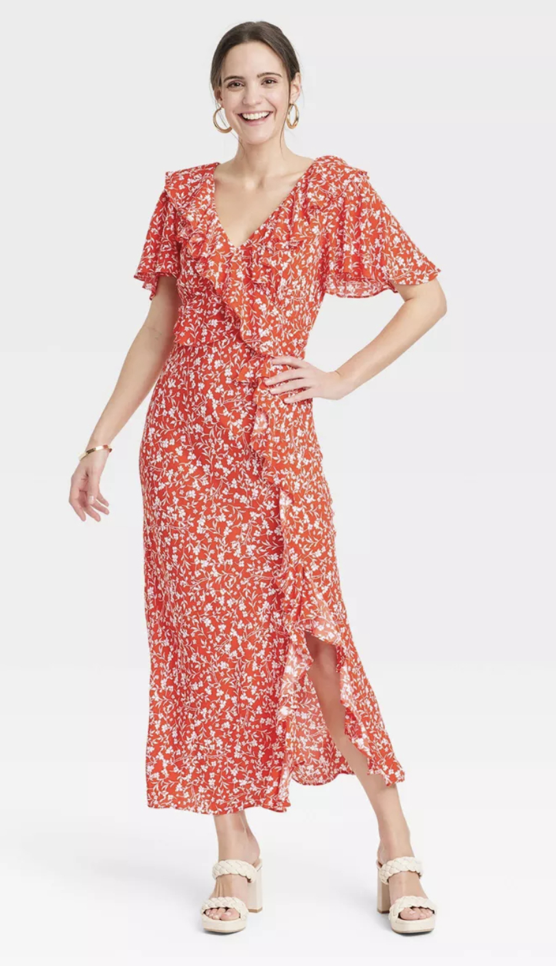person in wrap floral dress with short flutter sleeves and v-neckline
