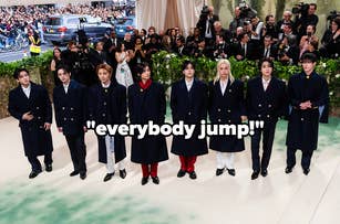 Seven members of BTS in formal suits at an event with a quote overlay "everybody jump!"