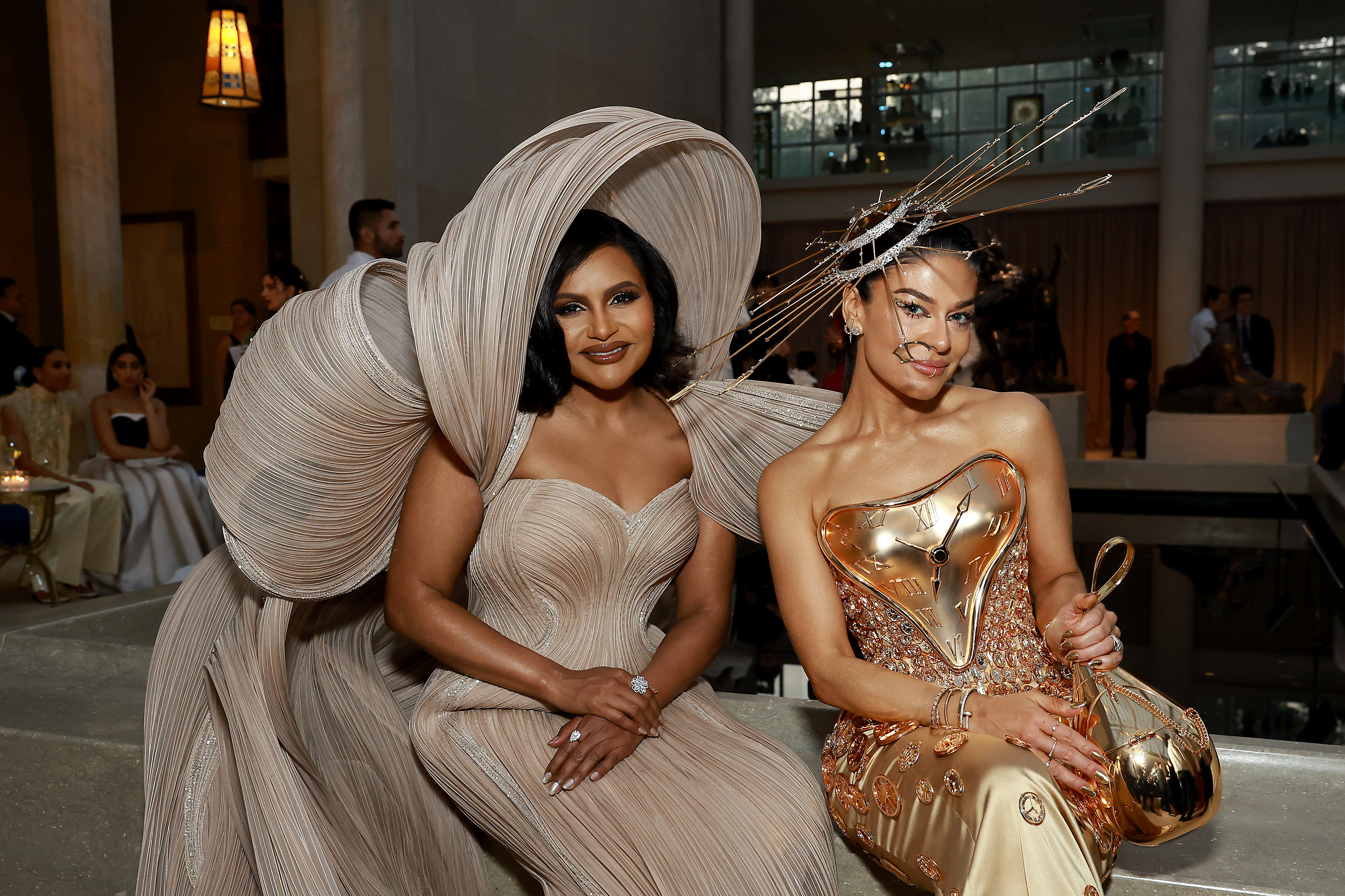 Mindy Kaling and another woman sitting at the Met Gala