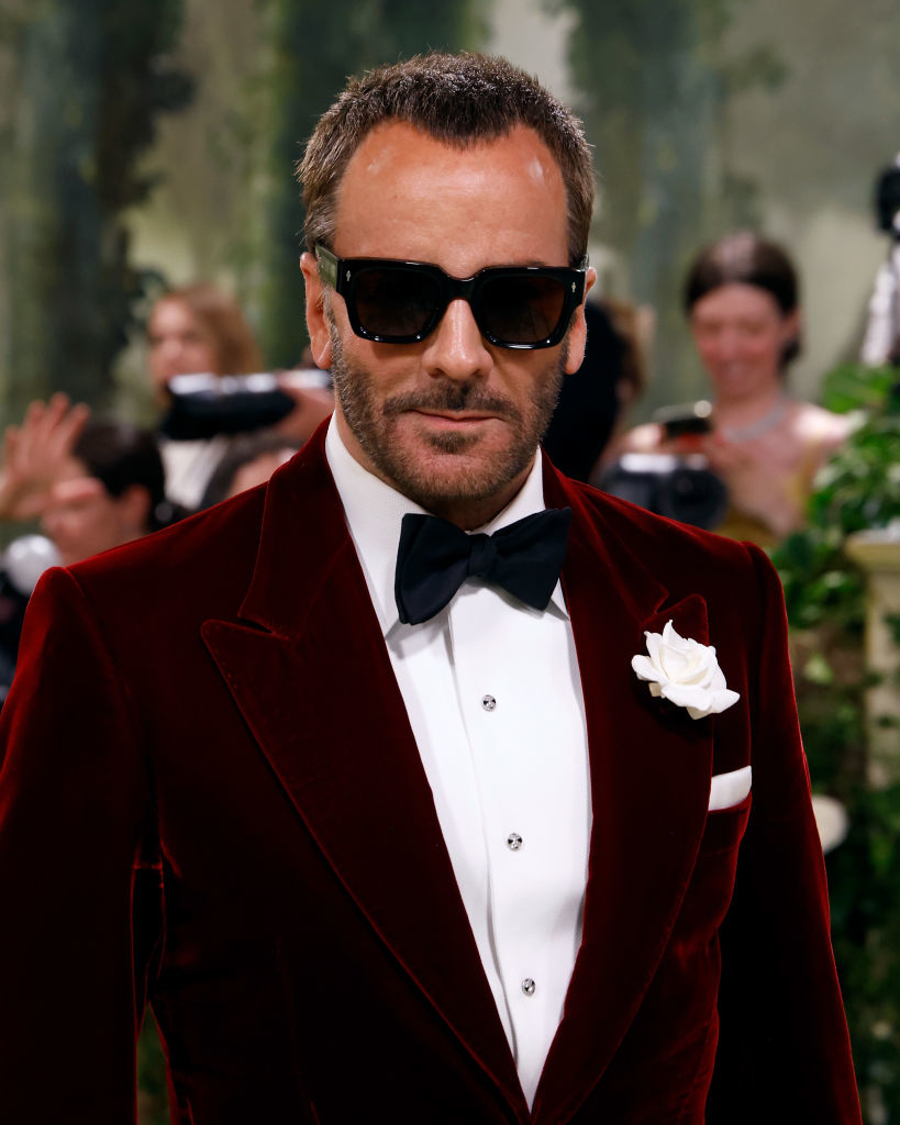 Tom Ford in velvet suit with bow tie and sunglasses at event