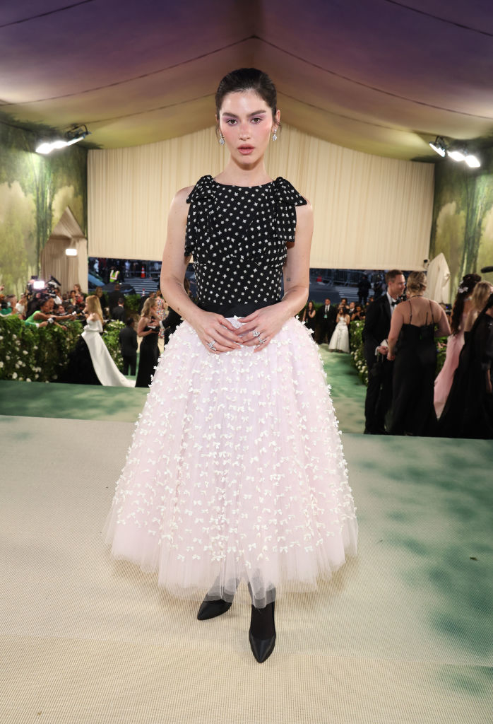 Gracie Abrams in a black polka dot top and a pink tiered tulle skirt at a gala event